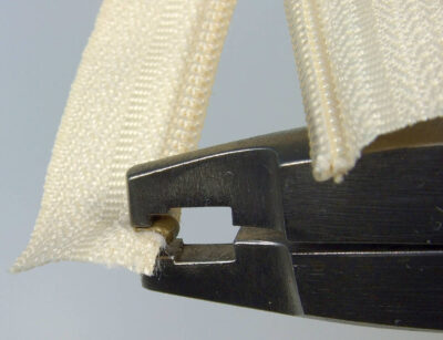 Pressing top stop using Osborne pliers – 3rd view