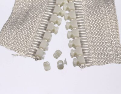 Protruding parts of 3 Delrin teeth cut off