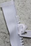 Delrin 9 slider in front of the Y-shaped top stop made by YKK