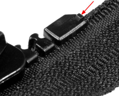 Molded top stop hidden on the slider side of a Delrin 9 zip fastener