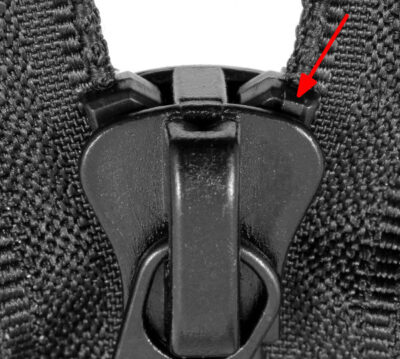 Molded top stops hidden in a Delrin 9 zip fastener slider